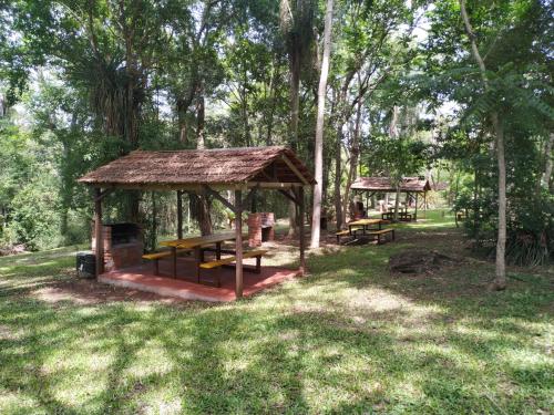 a picnic shelter in a park with trees at Complejo Paranay in Puerto Paranay