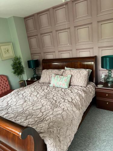 a bedroom with a large bed with a wooden headboard at Canalside B and B 