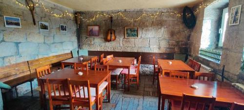 a dining room with wooden tables and chairs at Domek w Lesie in Karłów