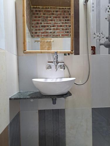 a bathroom with a sink and a mirror at Homestay field - bungalow, Ha giang loop tour, motorbikes rental in Ha Giang