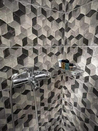 a shower in a bathroom with a tiled wall at Rhodes Central: King Bed Studio in Rhodes Town