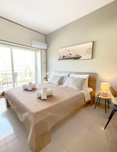 a bedroom with a large bed with two towels on it at Rhodes Central: King Bed Studio in Rhodes Town