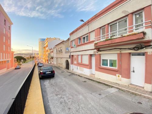 a car parked on a city street with buildings at Casa Alto Do Viso in Figueira da Foz