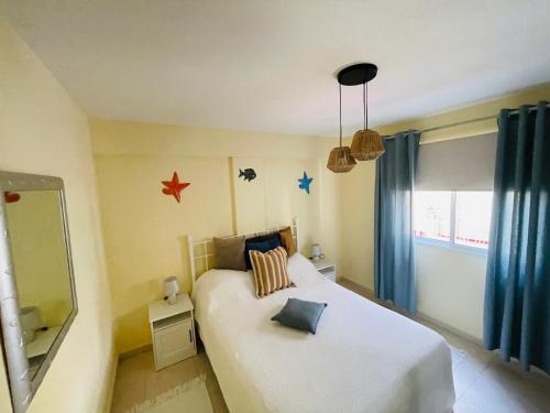 a bedroom with a white bed with stars on the wall at Mona's Point Tenerife in San Miguel de Abona