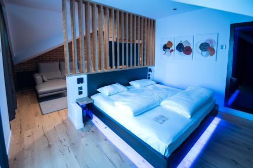 a bedroom with a bed with a blue light at Caro Hotel in Bucharest