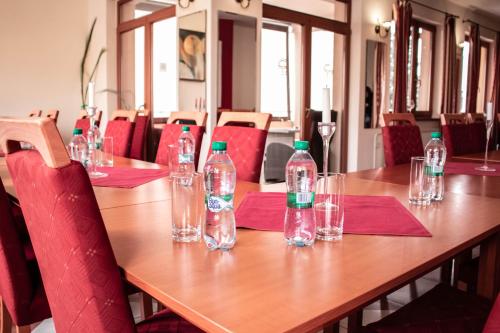 a long wooden table with empty water bottles on it at Penzión Tavel in Prešov
