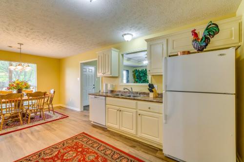 a kitchen with a white refrigerator and a table at Suburban Conway Vacation Rental 2 Mi to UCA! in Conway