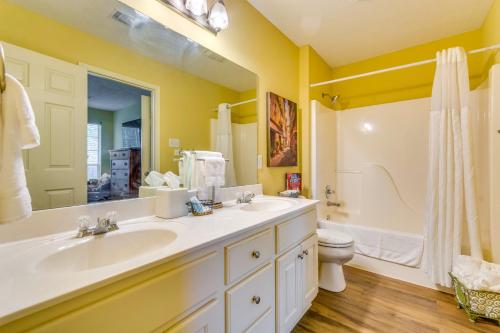 a bathroom with two sinks and a shower and a toilet at Suburban Conway Vacation Rental 2 Mi to UCA! in Conway