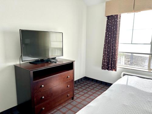 a bedroom with a dresser with a flat screen tv on it at La Quinta by Wyndham Bozeman in Bozeman
