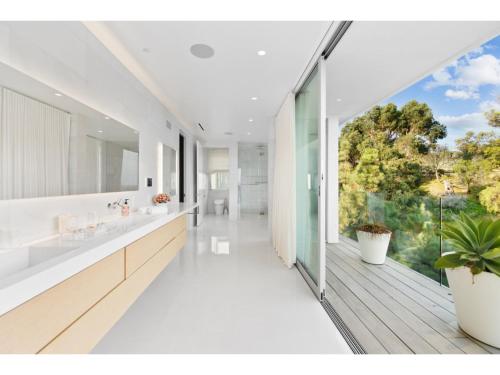 a bathroom with two sinks and a large window at Beverly Grove in Los Angeles