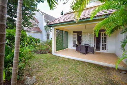 a house with a porch with a desk on it at Gunsite 28 by BSL Rentals in Bridgetown