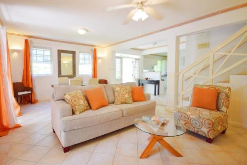 a living room with a couch and a table at Gunsite 28 by BSL Rentals in Bridgetown