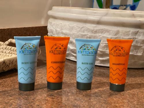 four tubes of sunscreen sitting on a counter at Kato Dool Wellness Resort in Aswan