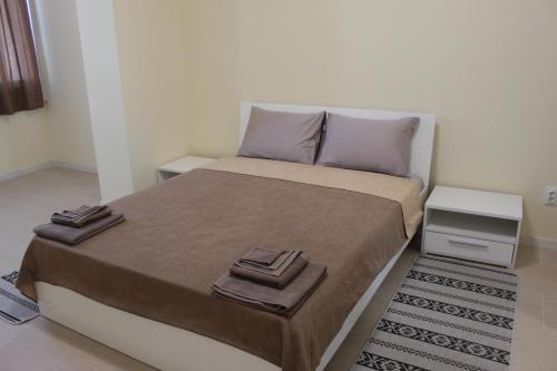 a bedroom with a bed with two towels on it at Готель Гармонія. Термально-оздоровчий комплекс. in Uzhhorod