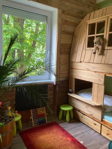 a childs play room with a bunk bed and a window at Pálmaház in Budapest