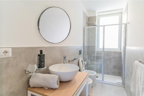 a bathroom with a sink and a mirror on the wall at Marina di Modica - Via del Laghetto in Marina di Modica