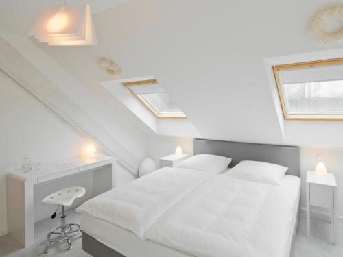 a white bedroom with a white bed and two windows at Schloss Hertefeld & Hertefeldhof in Weeze