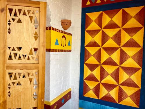 a room with a door and a colorful wall at Kato Dool Wellness Resort in Aswan