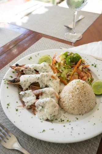 a plate of food with shrimp and rice on a table at Villa Marina Lodge & Condos in Playa Venao