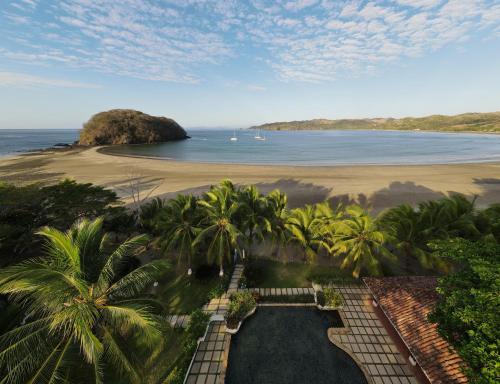an aerial view of a beach with palm trees and the ocean at Villa Marina Lodge & Condos in Playa Venao