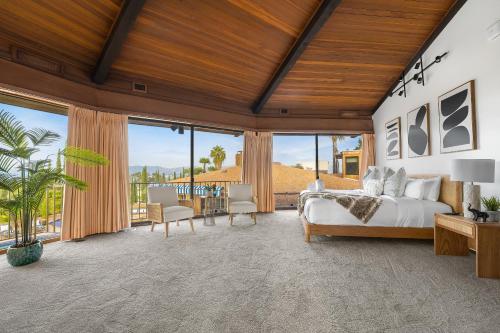 a bedroom with a bed and large windows at Via Vallarta in Los Angeles