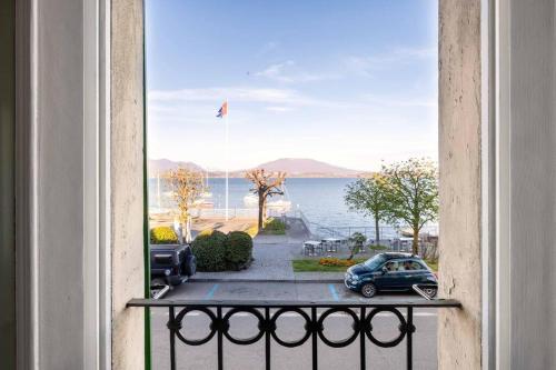 a view from a balcony with a car on the street at INCANTO Splendida vista lago in pieno centro in Lesa