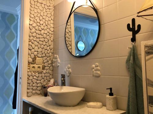 a bathroom with a sink and a mirror at Ma Mère Beach Condo Oostende in Ostend