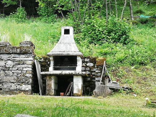 a bird house sitting on top of a stone wall at Chalet Niki BELLAGIO in Bellagio