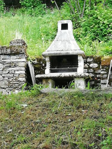 an old bird house sitting in the grass at Chalet Niki BELLAGIO in Bellagio