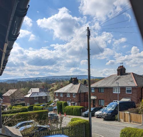 a view of a residential neighbourhood with houses and cars at Southsea in Coedpoeth