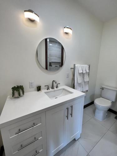 a white bathroom with a sink and a mirror at Monterey Inn in Monterey