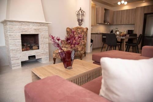 a living room with a couch and a fireplace at Mariangelas House in Kos