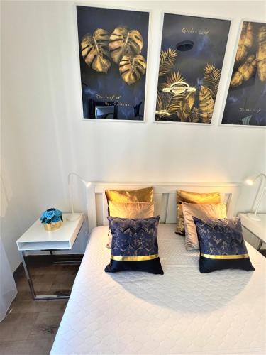 a bedroom with a bed with two pillows on it at Luxe Studio in City Center with FREE Parking in Budapest