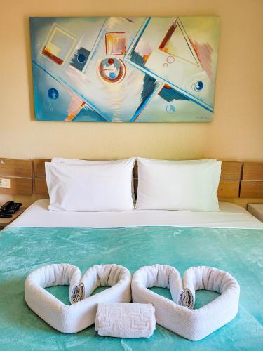 a bed with two inflatable towels on it at Estação do Sol Praia Hotel in Porto De Galinhas
