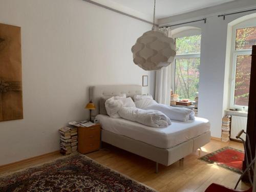 a bedroom with a bed with white sheets and a rug at Private Rooms in Hannover