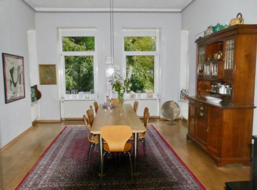 a dining room with a table and chairs at Private Rooms in Hannover