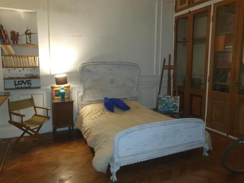 a bedroom with a bed with a blue bow on it at Plaza Congreso in Buenos Aires