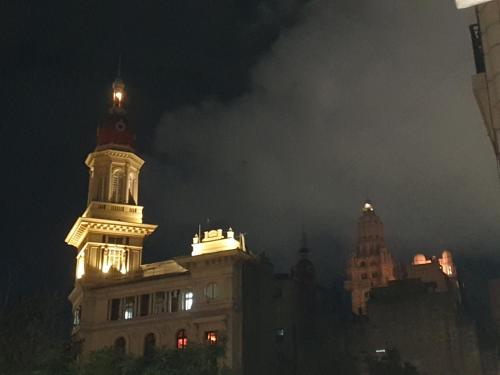 a tall building with a clock tower at night at Plaza Congreso in Buenos Aires