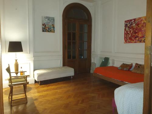 a room with two beds and a table and a lamp at Plaza Congreso in Buenos Aires