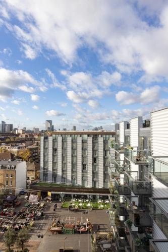 a large white building with a parking lot in front of it at Bermondsey Square Hotel - A Bespoke Hotel in London