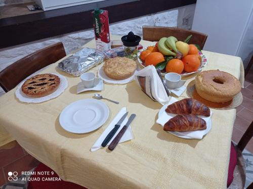 a table with bread and fruits and plates of food at B&B Giallo Siena in Colli al Volturno