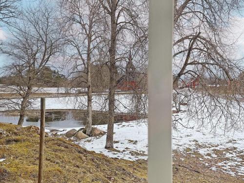 a view of a river with snow and trees at 4 person holiday home in ANEBY-By Traum in Aneby