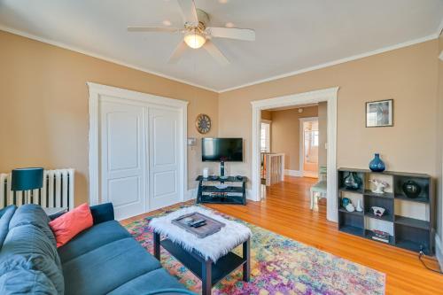 a living room with a blue couch and a tv at Revere Vacation Rental Near MBTA about 7 Mi to Boston! in Revere