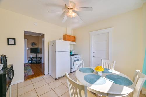 a kitchen and dining room with a white table and chairs at Revere Vacation Rental Near MBTA about 7 Mi to Boston! in Revere
