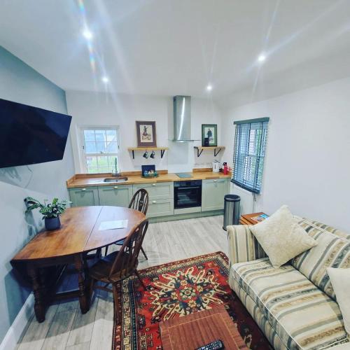 a living room with a table and a couch at Conon Hotel in Dingwall
