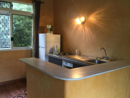La cuisine est équipée d'un évier et d'un réfrigérateur. dans l'établissement Villa MERAHI ... La villa d'Ange Fare Noa Mymy, à Uturoa