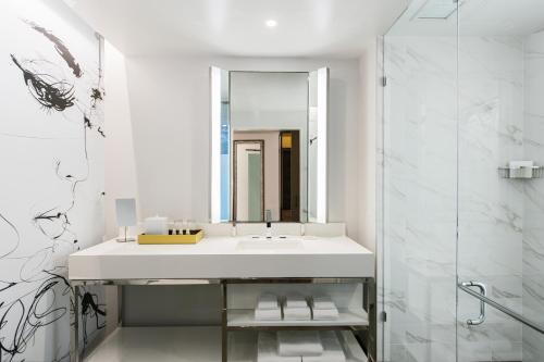 a bathroom with a sink and a mirror at Renaissance Atlanta Airport Gateway Hotel in Atlanta