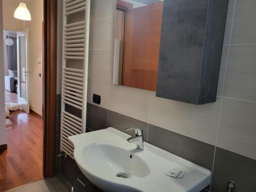 uma casa de banho com um lavatório branco e um espelho. em Appartamento Vacanze Euganea em Rovolon