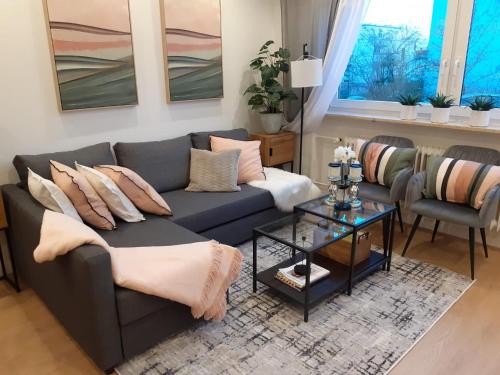 a living room with a couch and a table at NEW - Apartment Kameni Confort Wifi Munich Airport Family in Neufahrn bei Freising