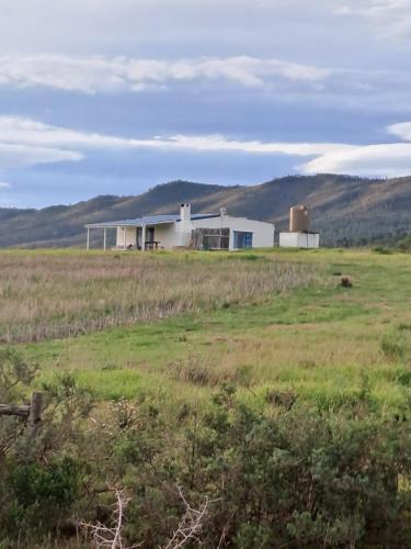 a barn in the middle of a field at Ou Werf Farm Cottage in Bredasdorp